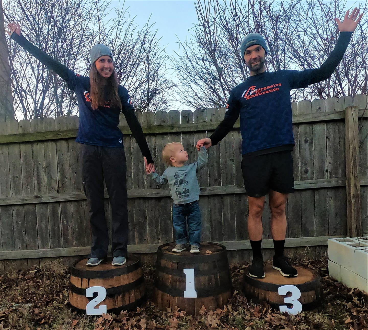 Family standing on an early bourbon barrel podium that inspired the business